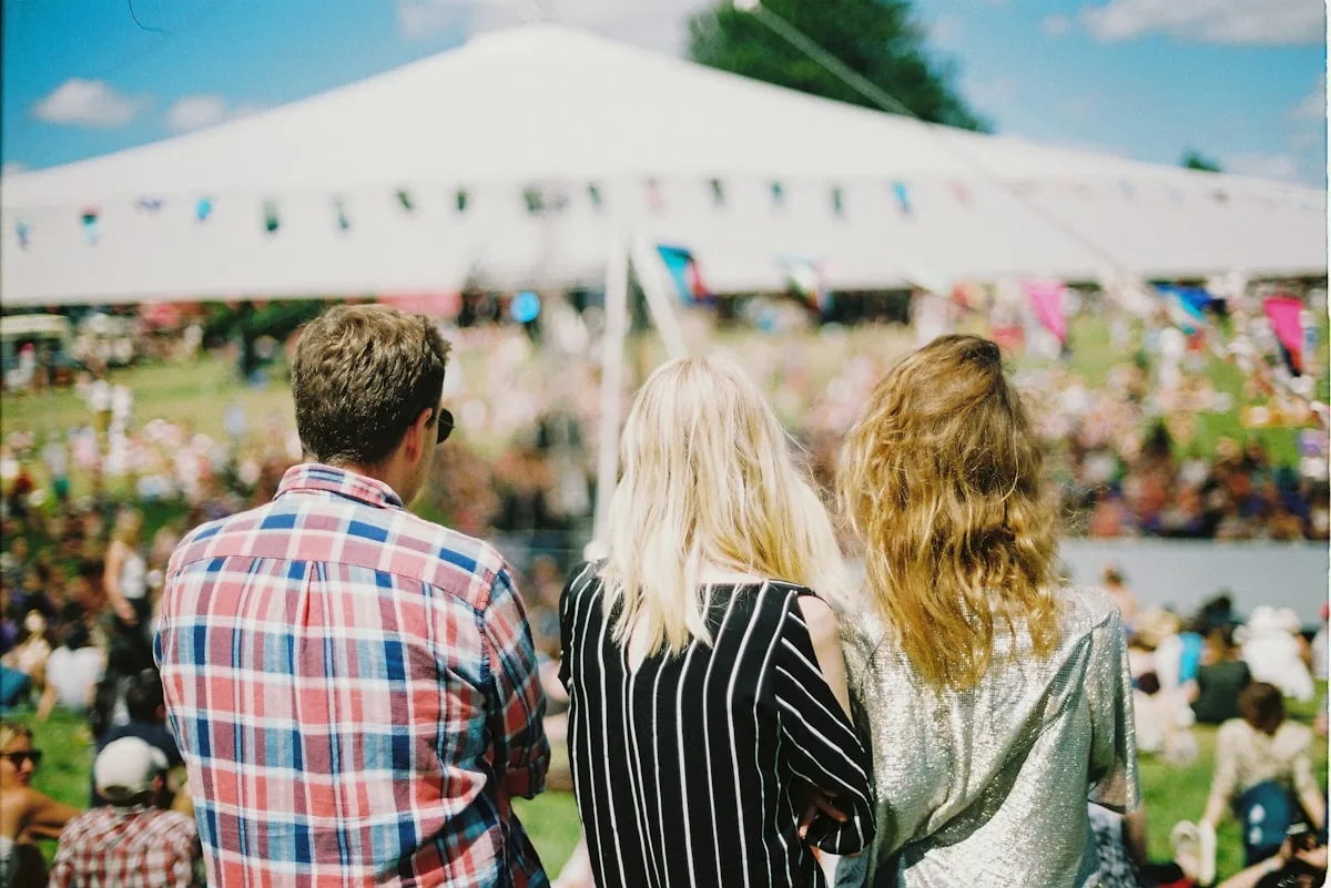 Excited festival crowd dancing and enjoying outdoor summer event